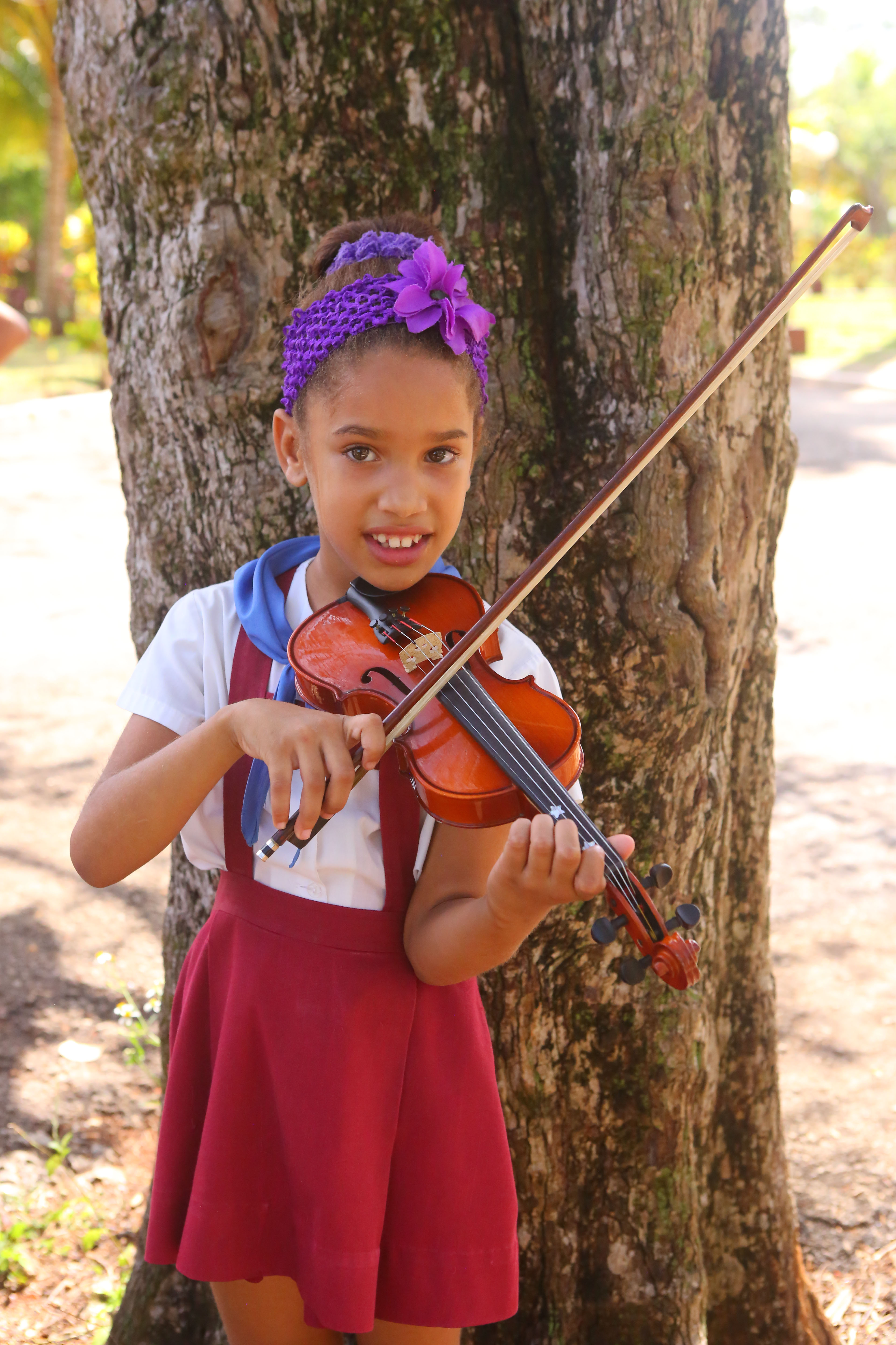 Adianez Morel with a viola gifted by U.S. visitors at Escuela de Arte Eduardo Abela, in San Antonio de los Baños.